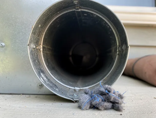 Tamiami Dryer Vent Cleaning technician using specialized equipment to clear severe dryer vent blockage in Tamiami